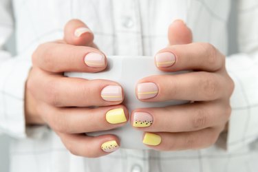 Manicured hands holding a cup of coffee or tea