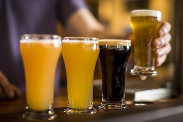 Tasting beer at the bar. Close up on beer flights.