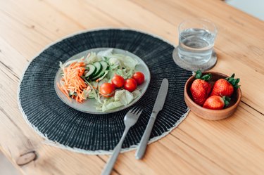 Close up of a fresh vegetable salad on a wooden kitchen table