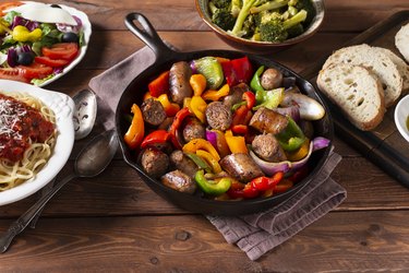 Venison deer sausage and onions and peppers being cooked in a skillet