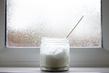 jar of coconut oil by bathroom window