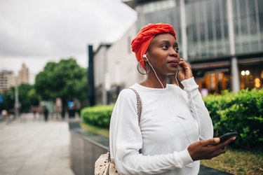 Black woman listening to music and humming