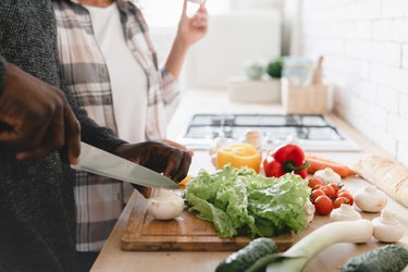 close view of african-american couple cooking together in the kitchen in order to help with insulin resistance