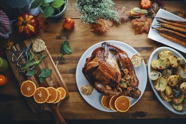 Holiday turkey cooked without an oven, on holiday table with sides and fall theme