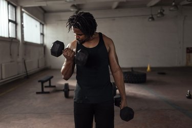 Man performing drop set with biceps curls.