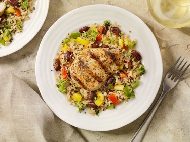 overhead closeup of Chicken with Quinoa and Brown Rice in white bowl with fork