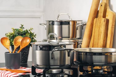 Clean saucepans on a gas stove in kitchen