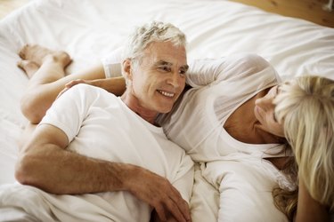 Mature couple lying on bed