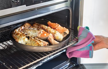 To remove the grilled lobster from the oven