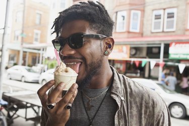 A young man eating ice cream, as an example of what causes brain freeze