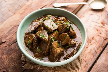 biotin-rich beef liver in bowl on wooden table