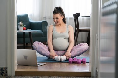 Beautiful pregnant woman exercise at home