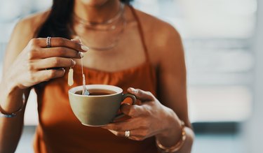 woman steeping herbal tea for weight loss