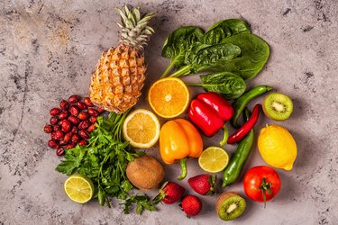 overhead photo of fruits and vegetables rich in vitamin C like pineapple and bell pepper