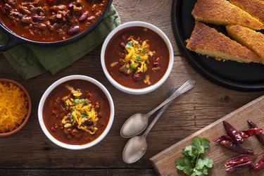 top view of two bowls of spicy chili with hot peppers