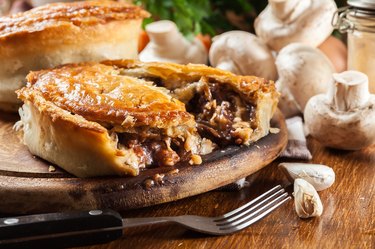 Fresh beef stew meat pie on a cutting board