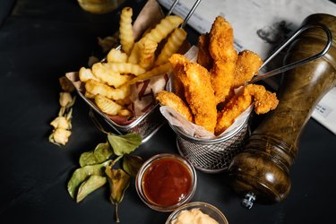 Fried chicken breast, chicken tenders or fingers served at restaurant with fries