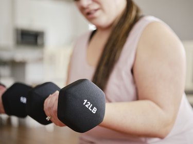 Woman Using Exercise Weights in a Home