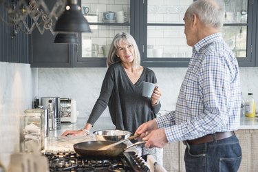 A senior couple cooking in the kitchen
