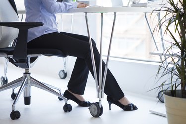 Feet of the woman working in the office