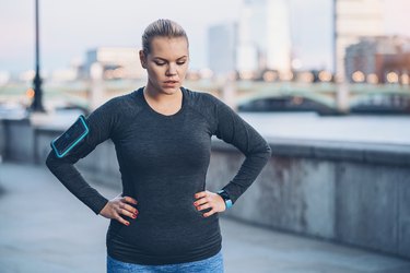 Woman taking a break, feeling nauseous after workout