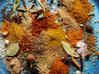 Variety of colorful spices on blue plate for tamarind allergy