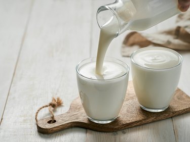 Pouring homemade histamine-rich kefir, buttermilk or yogurt