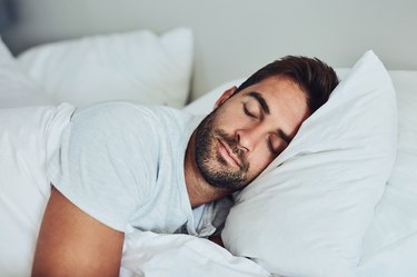 a man sleeping on his side, as a natural remedy for snoring