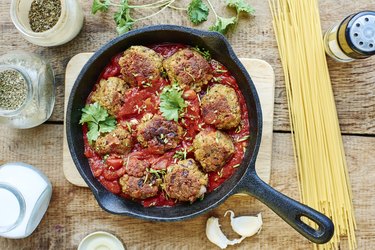 Vegan meatless balls made from TVP in tomato sauce in a cast iron pan