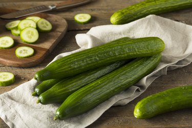 raw cucumbers with their peels on a kitchen towel on a table