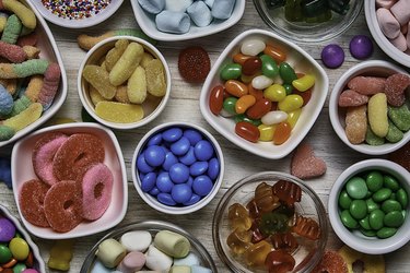Top view of bowls of various candies, as an example of things that may trigger an epileptic fit