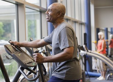 Older adult working out on an elliptical machine to get back in shape