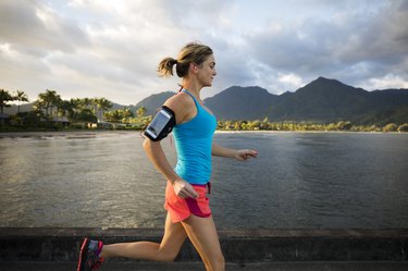A female jogging near the ocean wearing women's workout shorts