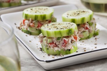 Cucumber stack with tuna salad on white serving dish
