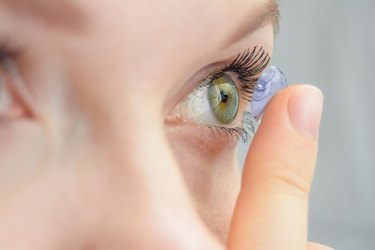 close view of a person putting in contacts