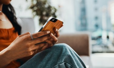 A woman using the Dr. B site on her phone to find a COVID vaccine