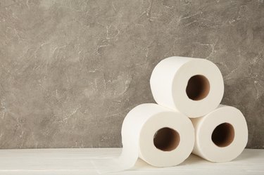 Toilet paper close-up on grey background with copy space