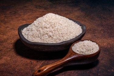 The white rice in the bowl is on the dark background