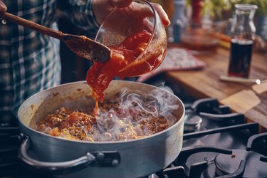 Preparing Homemade Spaghetti Bolognese with gluten free spaghetti sauce