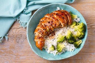 Chicken breast in balsamic vinegar and brown sugar sauce sprinkled with sesame seeds. Chicken with rice and broccoli