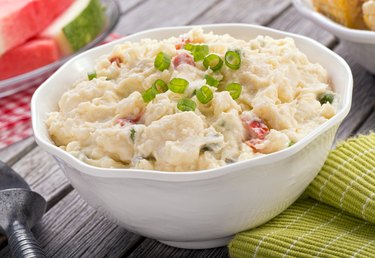 Freshly made potato salad with spring onions on top