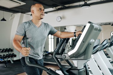 Man working out on elliptical machine