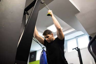 Person working out in gym using the ski erg machine.