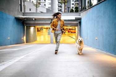 Young man running with his dog, as an example of what to do to reverse prediabetes