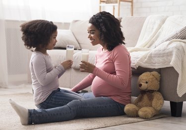 Mother and daughter drinking glass of gluten-free milk.