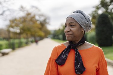 Black woman walking outside in a park, doing a walking meditation