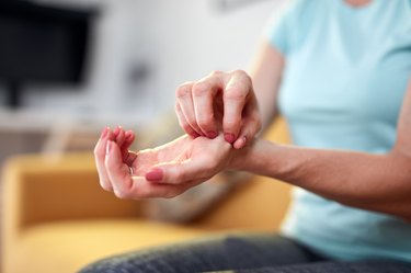 close view of a person scratching their hands because they have itchy palms