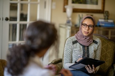 a therapist speaks with a client managing SAD in a home office