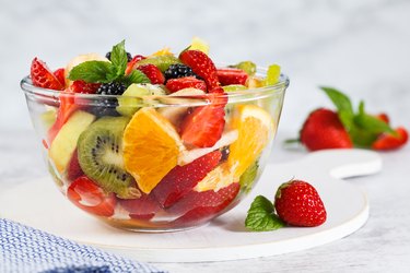 Delicious fruit salad on a plate on table.
