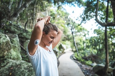 Young sporty woman with type 1 diabetes getting ready for a run